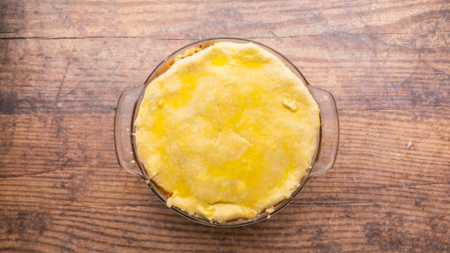 Gently lay your beef pie crust over the top, sealing the edges well and cutting a few steam vents in the top with a knife