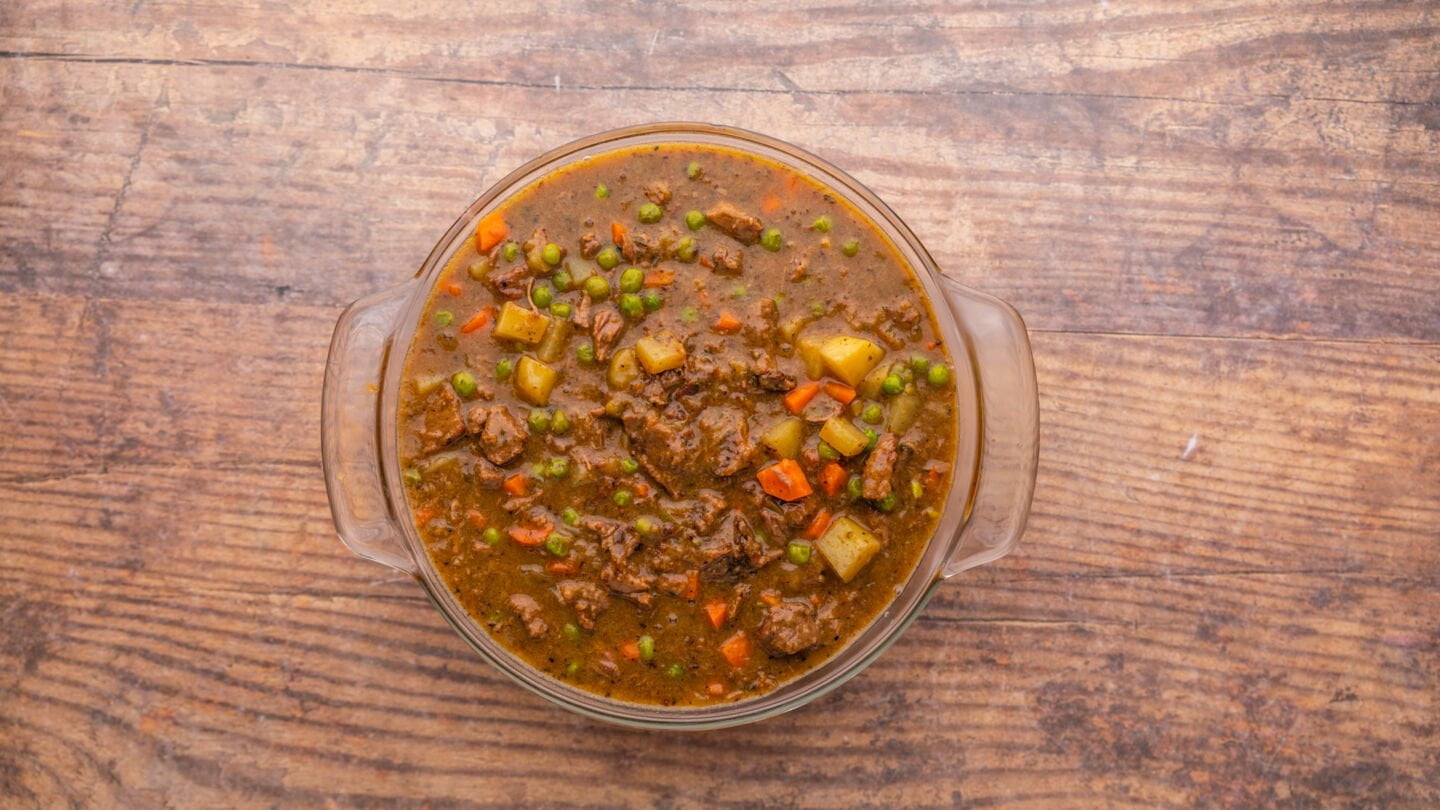 Lightly grease a large pie plate or pie dish and pour in the tender beef stew