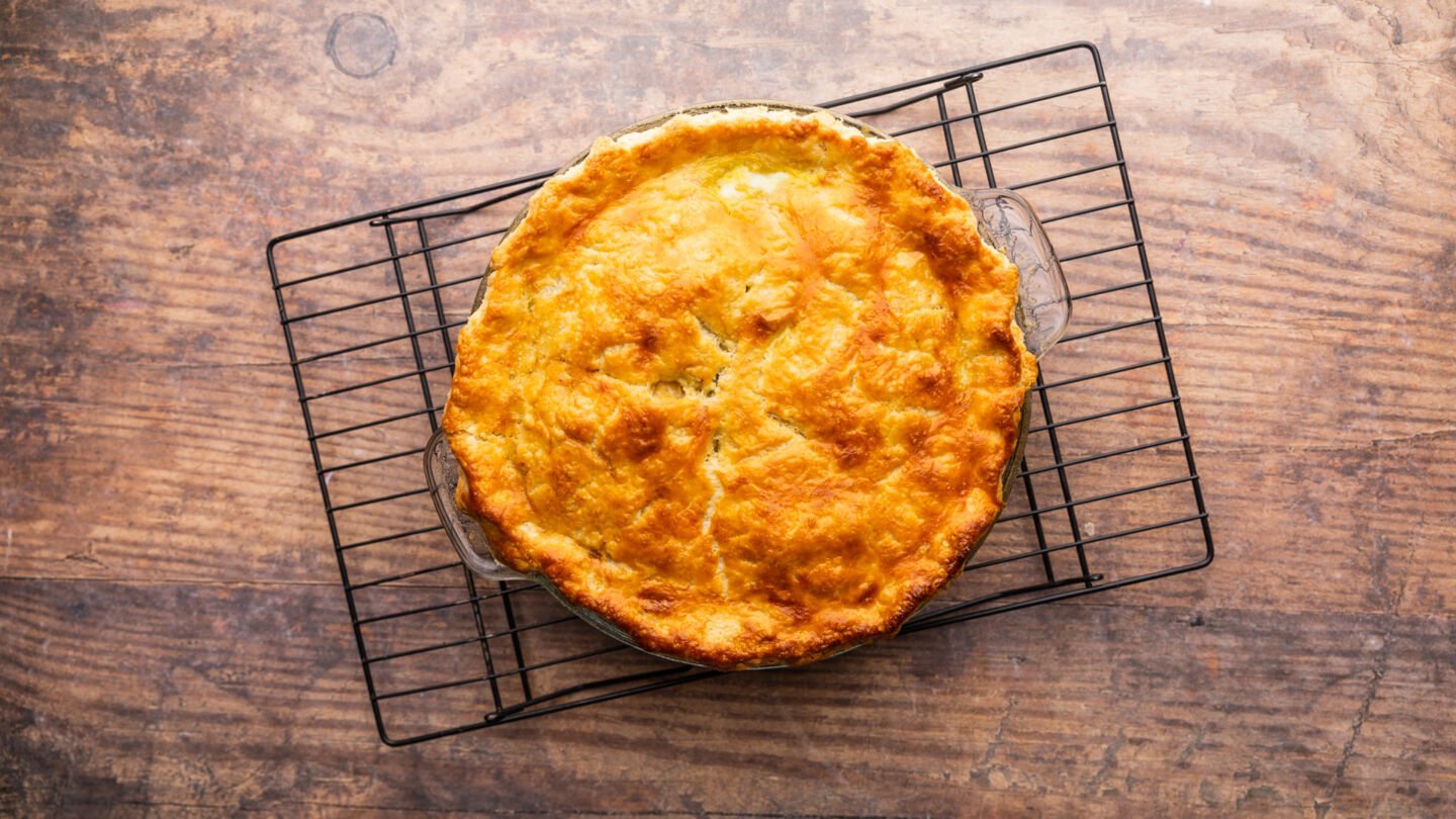 Bake the chicken pie in the preheated oven for 30-35 minutes until the top crust is golden brown