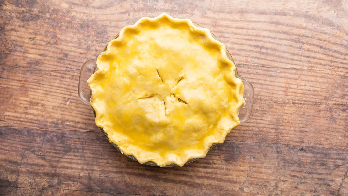 Roll the second disk of pie dough into a 10” diameter circle and place it over the pie filling