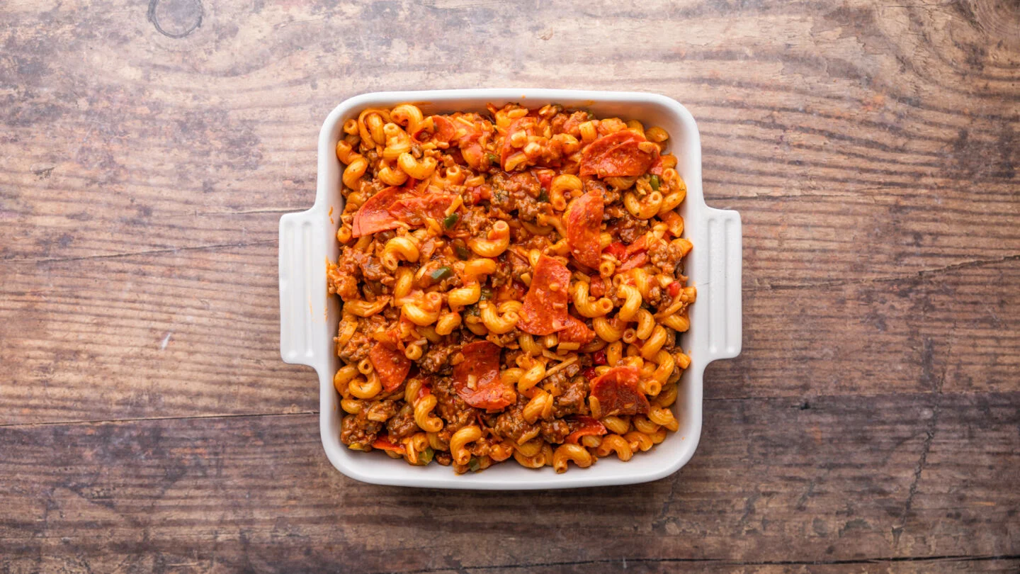 Stir to thoroughly combine the meat sauce before pouring it into the casserole dish.