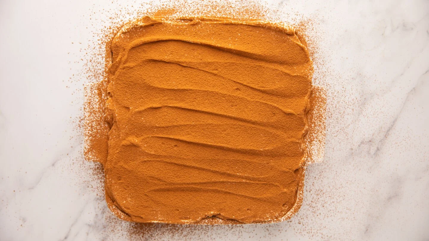 Smooth the top with a knife or spatula and dust with cocoa powder