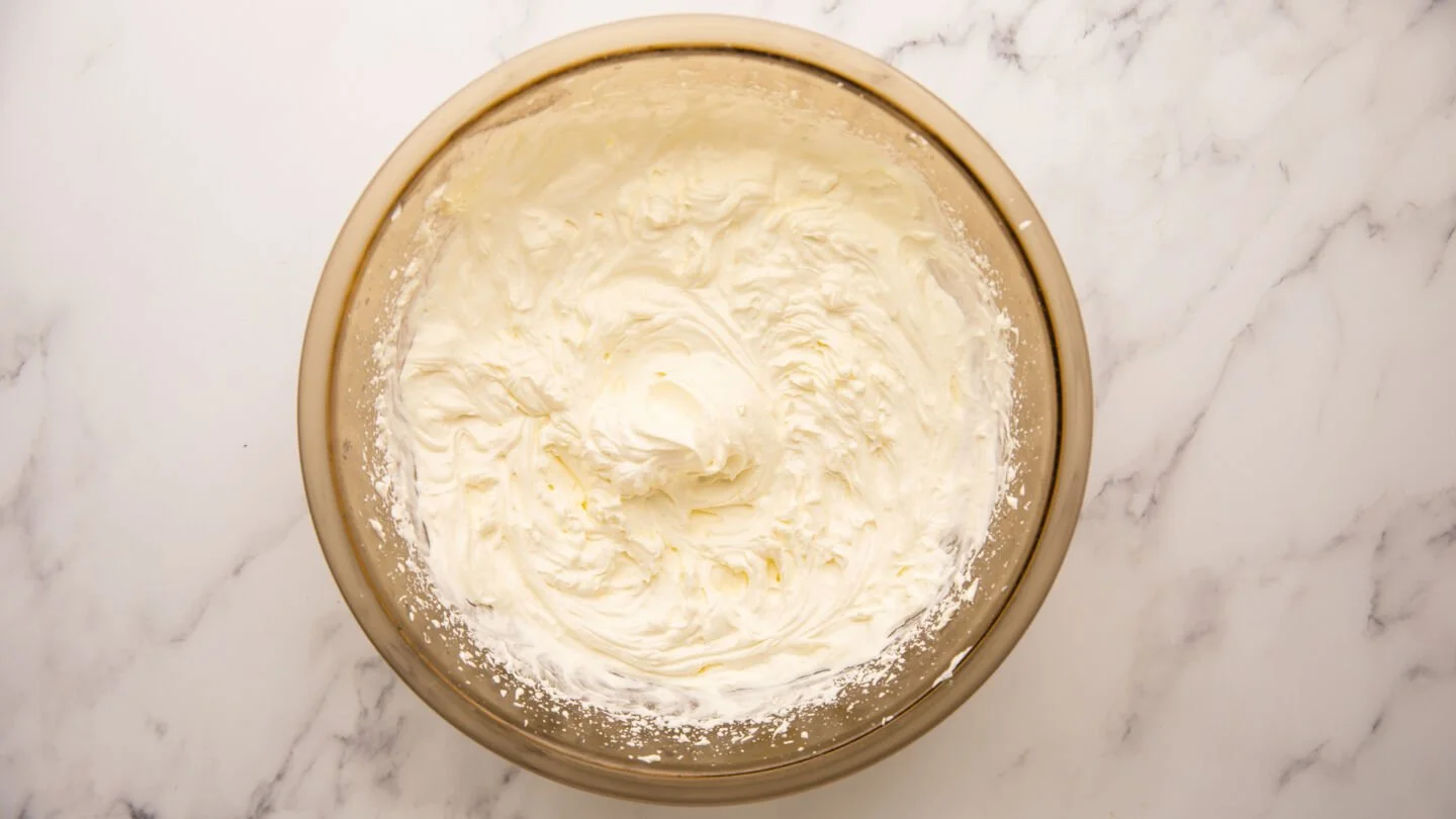 Slowly add the granulated sugar and vanilla to the whipped cream