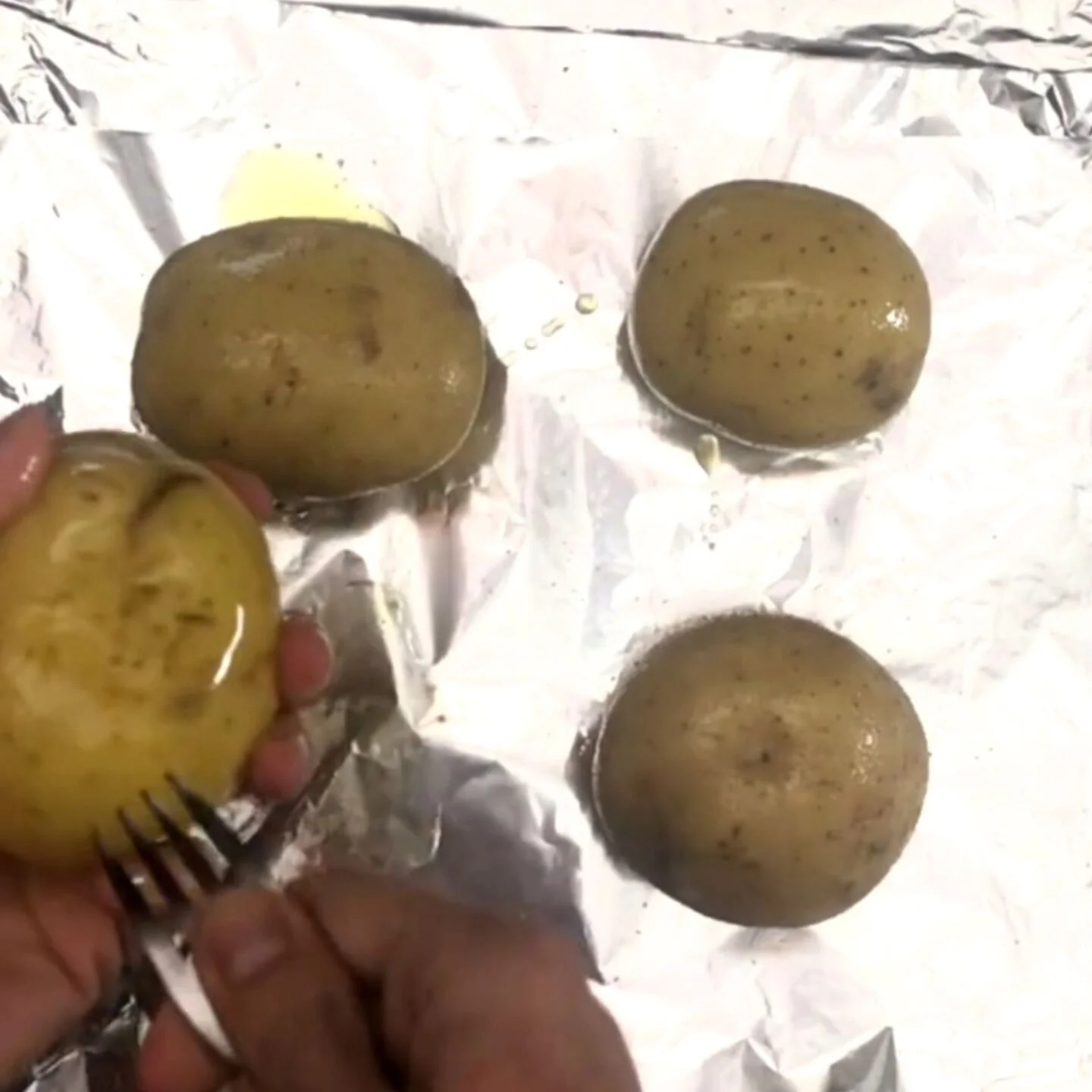 potatoes a few times with a fork and rub them with olive oil and salt.