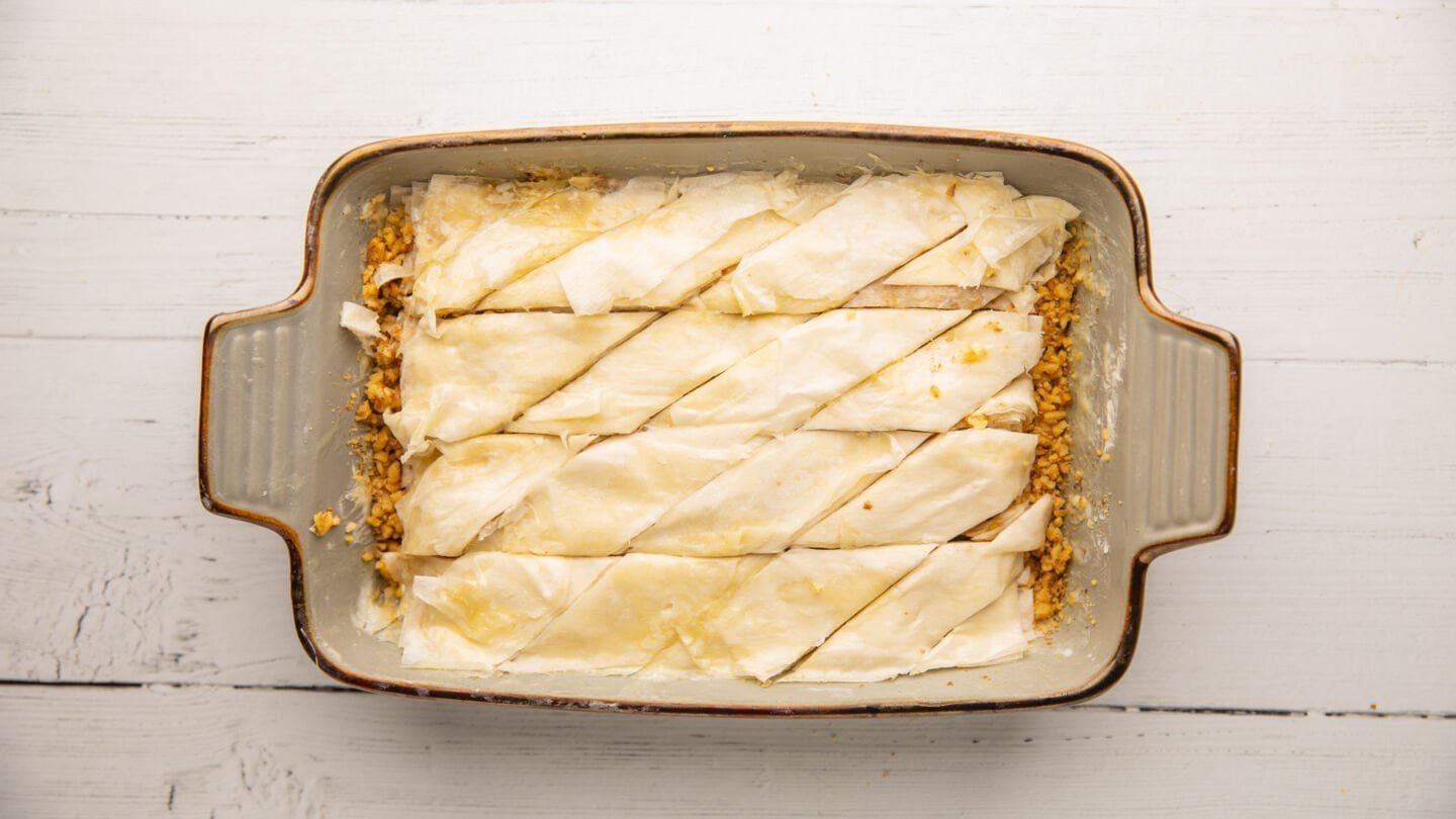 Use a sharp knife to cut the baklava lengthways 4 or 5 times and then cut across it diagonally