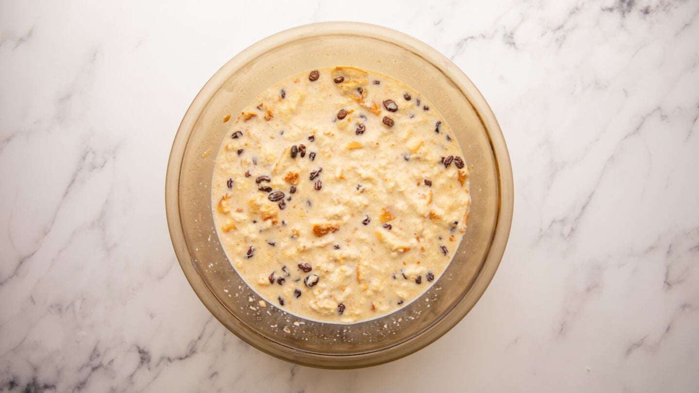 Pour the custard mixture over the soaked bread and stir in the bourbon-soaked raisins