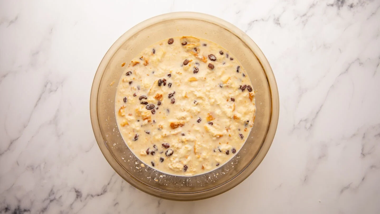 Pour the custard mixture over the soaked bread and stir in the bourbon-soaked raisins