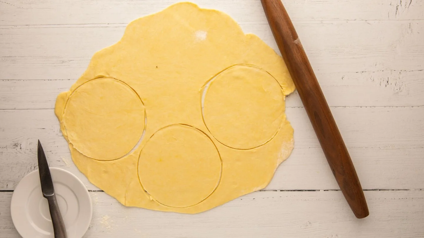 Cut out round disc shapes using a pastry cutter, round molds