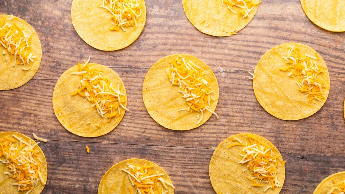 Divide the shredded cheese among the tortillas and then spoon the taco meat on top