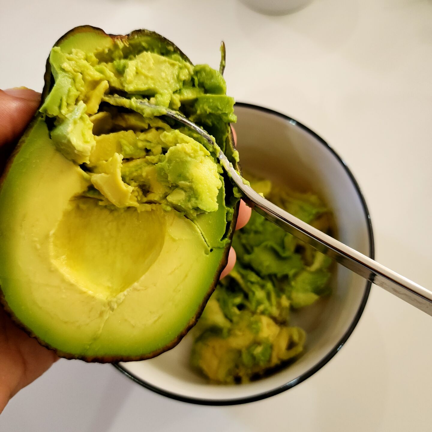 Cut the avocado in half, scoop out the avocado flesh and mash