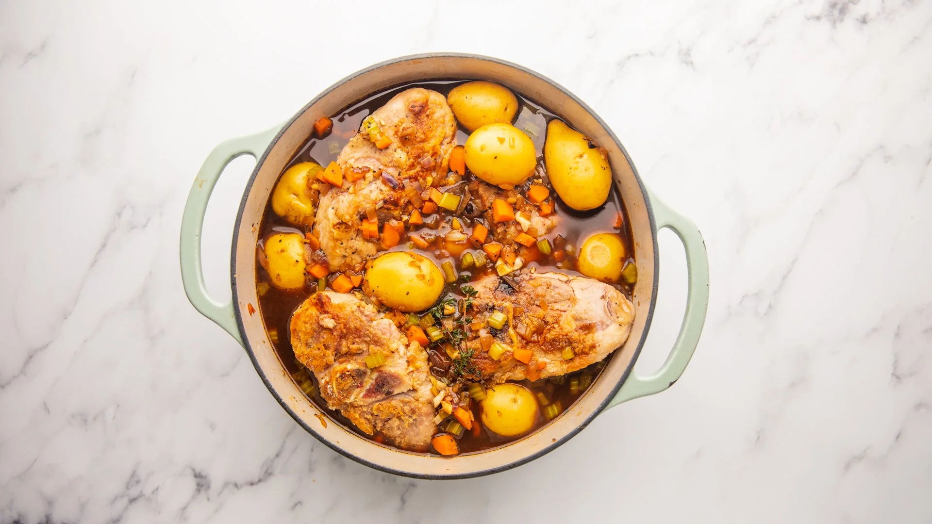 Pour the vegetables and broth over the shanks