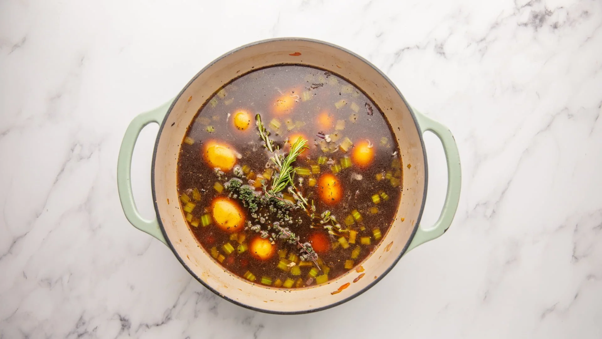 Add the stock, freshly chopped herbs, tomato paste, salt, and pepper