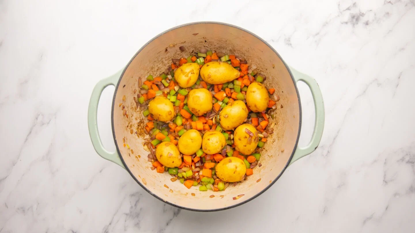 add the chopped vegetables and baby potatoes to the pot