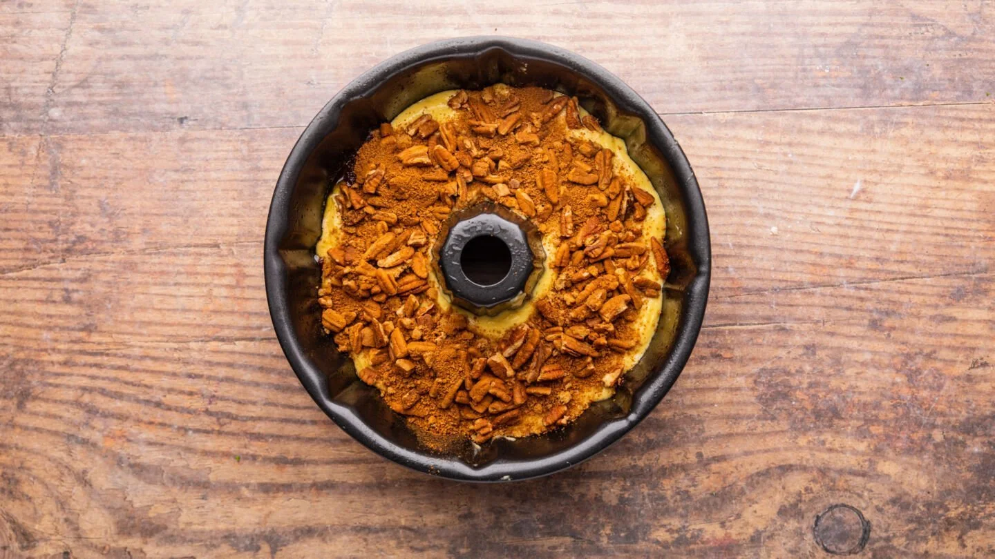 pour the pecan mixture over the batter in the prepared pan