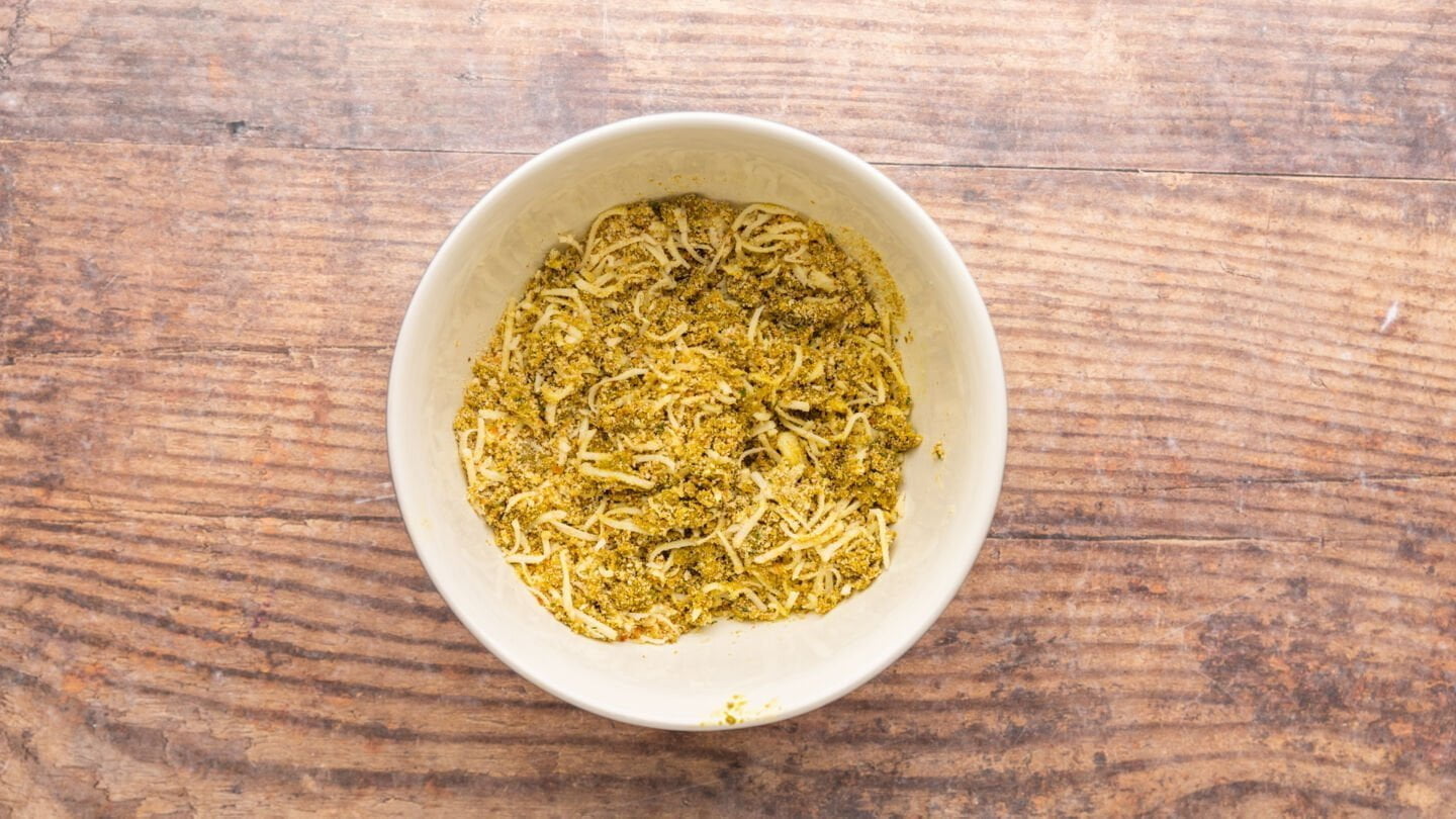 Combine the pesto sauce, shredded mozzarella cheese, and bread crumbs in a bowl