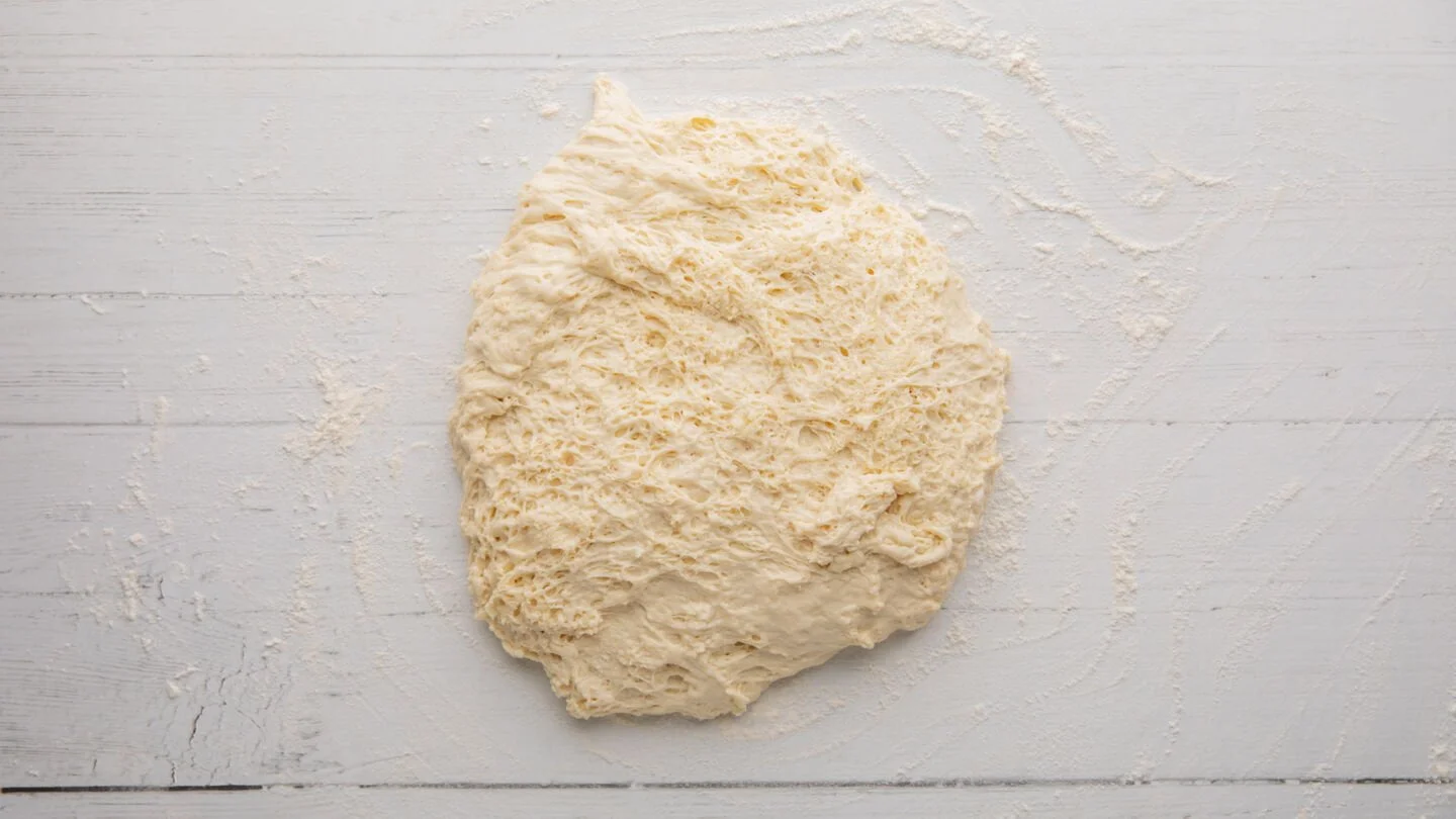  turn it out onto a lightly floured surface and cut the dough in half.