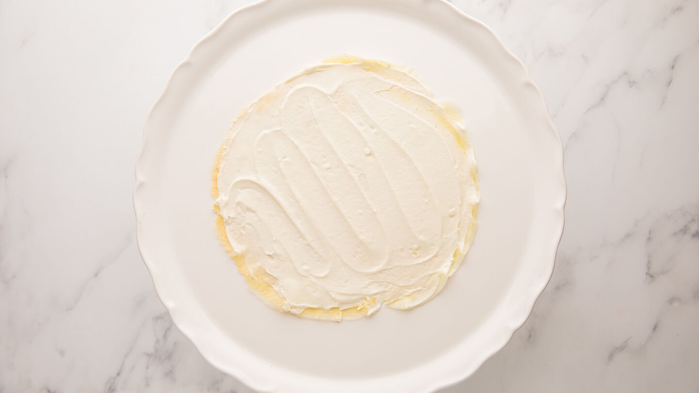 place 1 cooled crepe on a serving plate or cake stand and spread 3 tablespoons of cream filling evenly on top