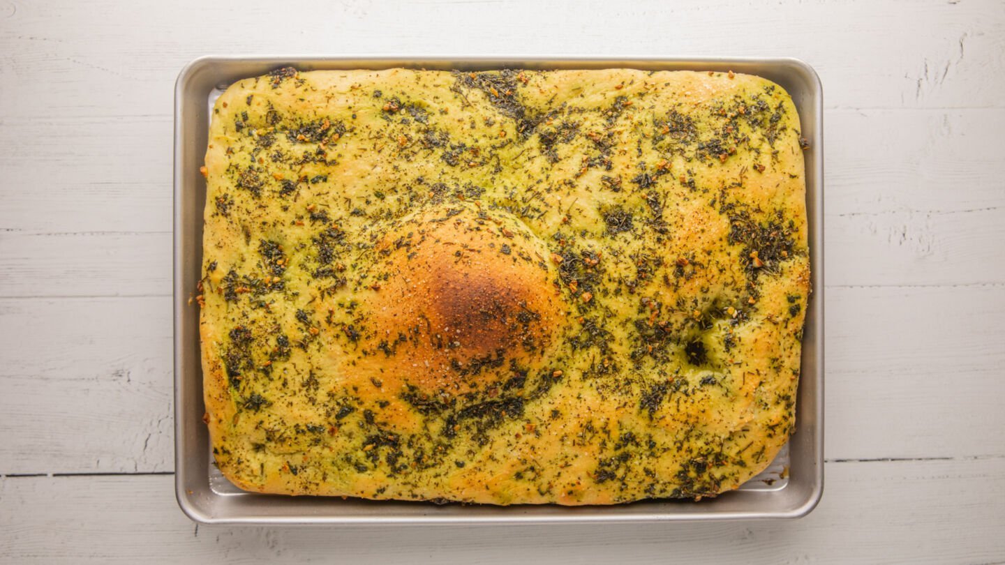 Bake the homemade focaccia in the preheated oven for around 22 minutes until the top is golden brown