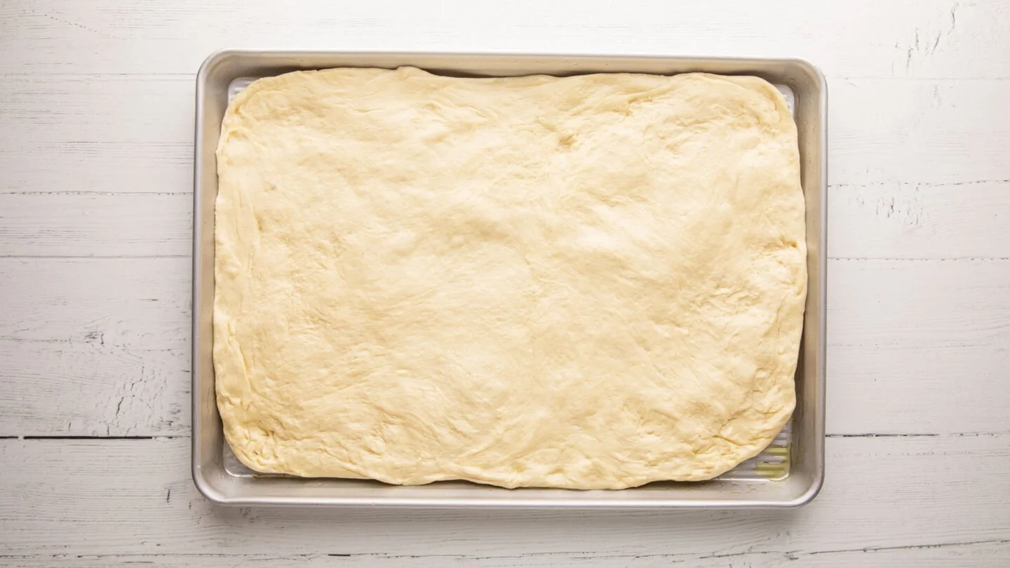 transfer it to a baking sheet or dish (oiled well with olive oil)