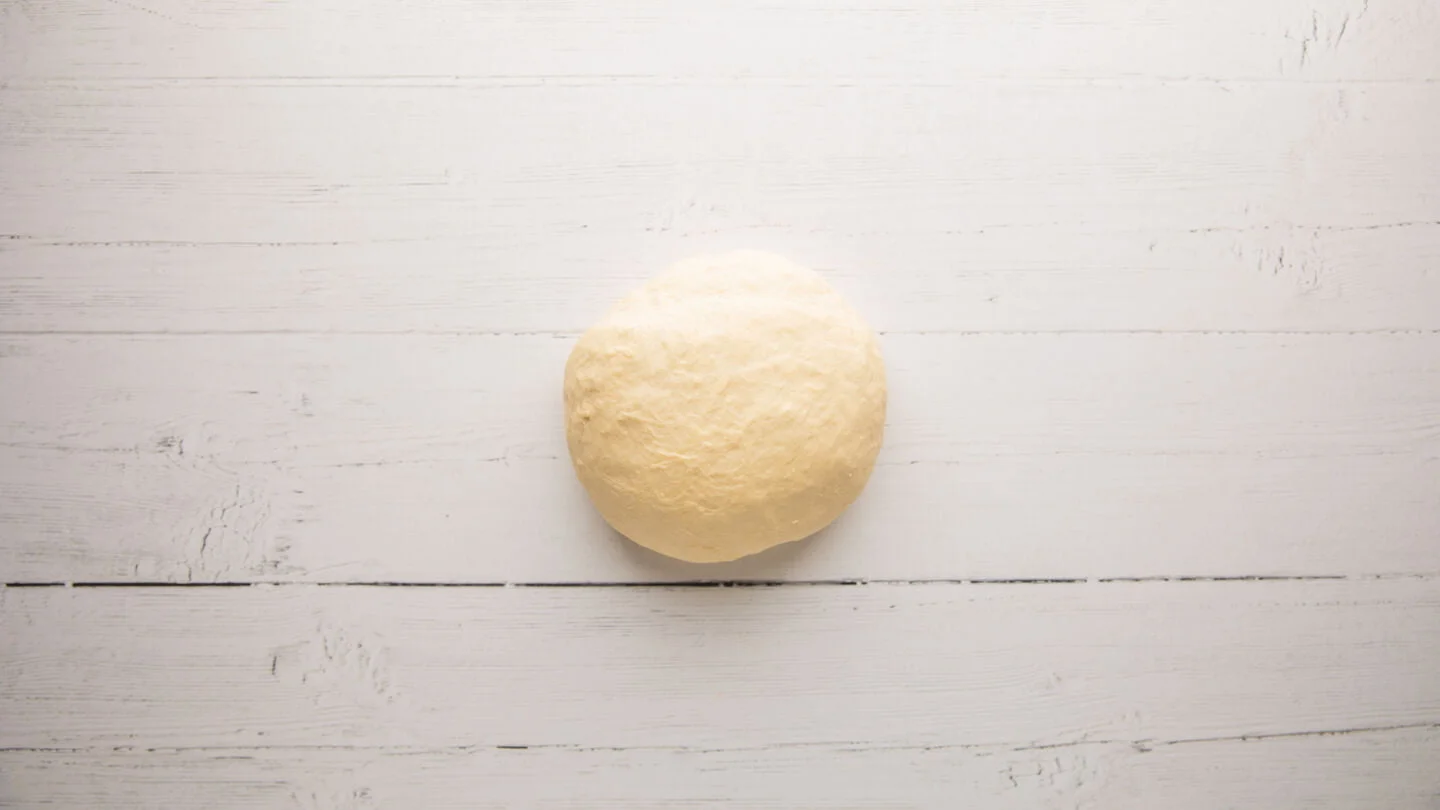 Transfer the dough to a lightly floured surface and knead it for 1 to 2 minutes until the focaccia dough is soft to the touch and it springs back when pressed