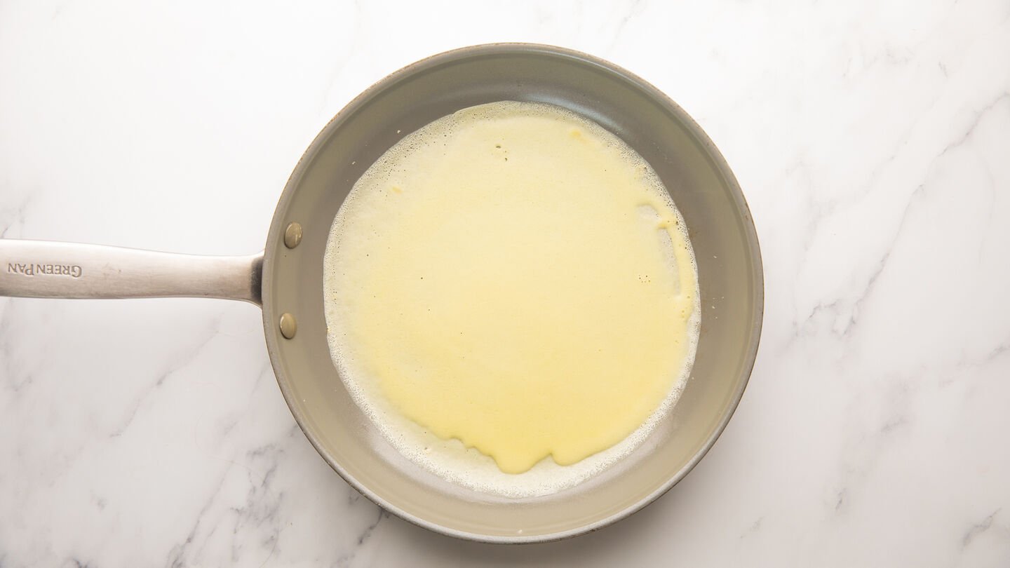 Once butter is hot, add about 3 tablespoon of batter, or enough to lightly coat the bottom of the pan, swirling the skillet as you add the batter to evenly coat the bottom of pan.