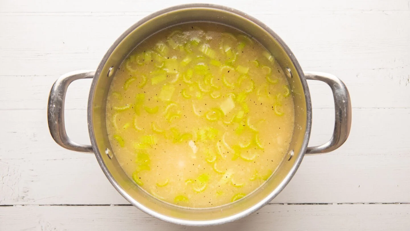 Combine the broth, celery, cooked chicken, soup, water, and broth in a wide soup pot
