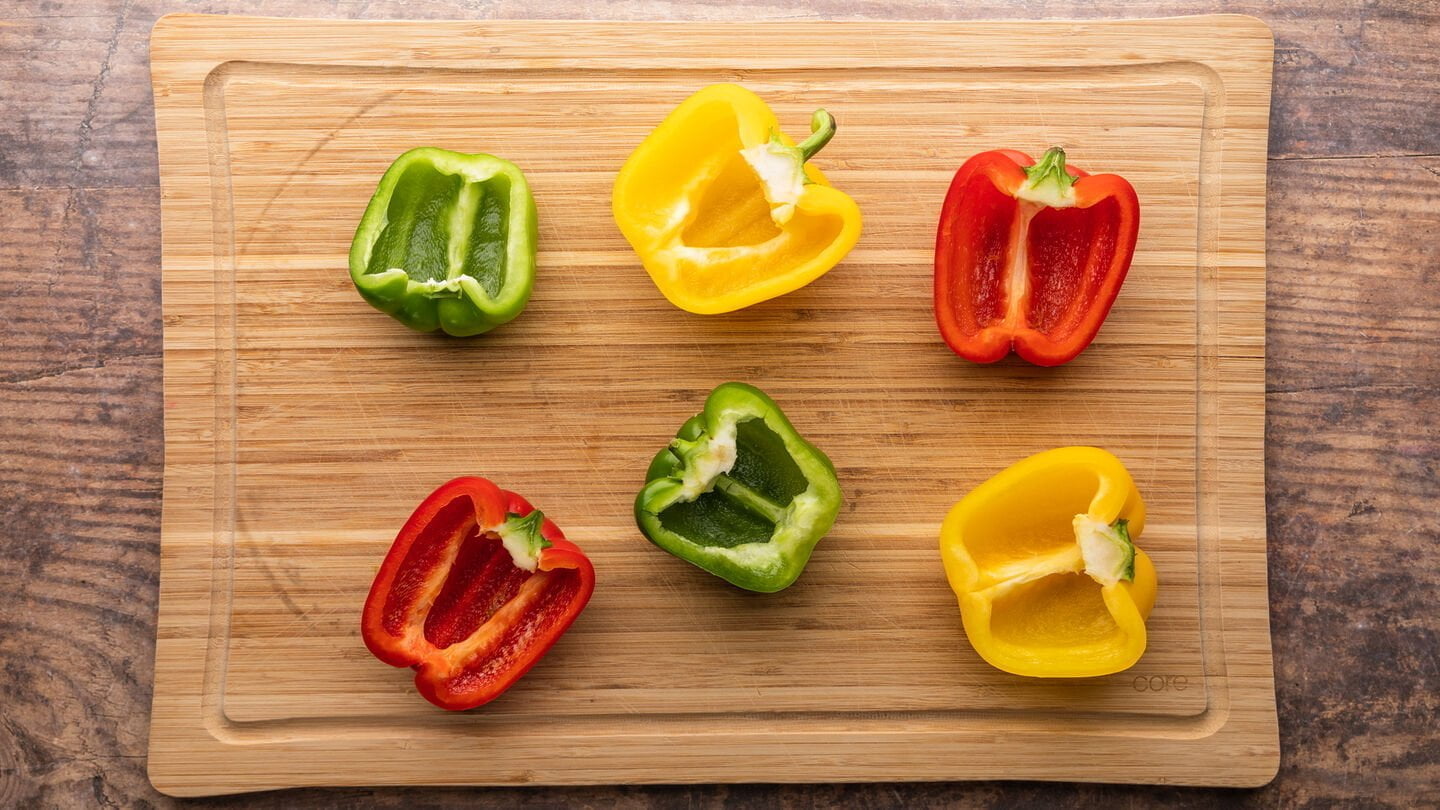 Wash and cut the red bell peppers in half (