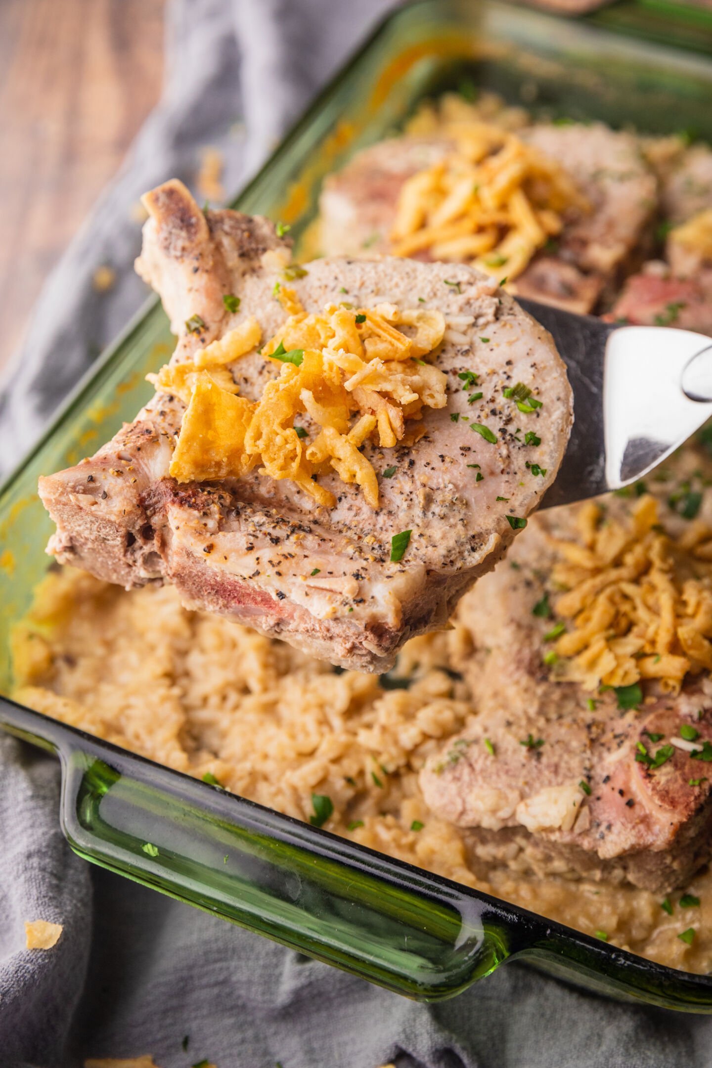 baked pork chops on top of rice