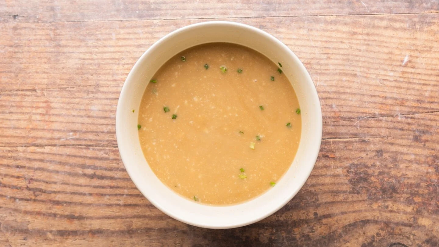 soup, rice, broth, and seasoning in a bowl 