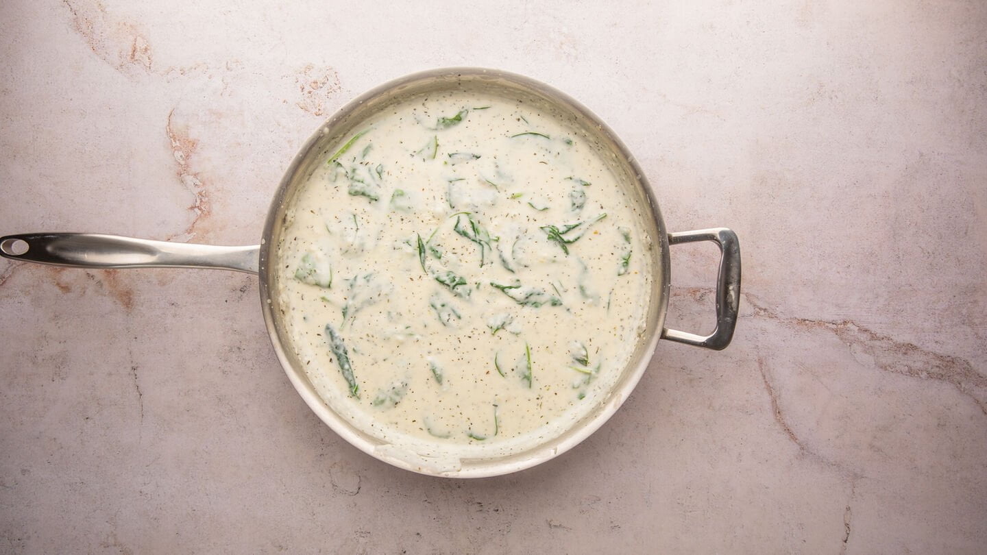 addition of dried herbs and spinach to the white sauce